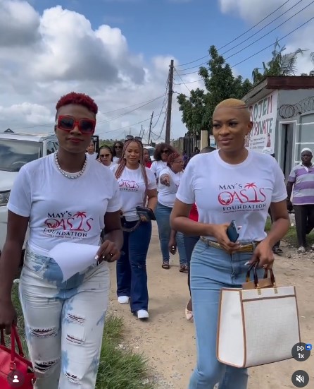 Foundation volunteers walking through a community on outreach day