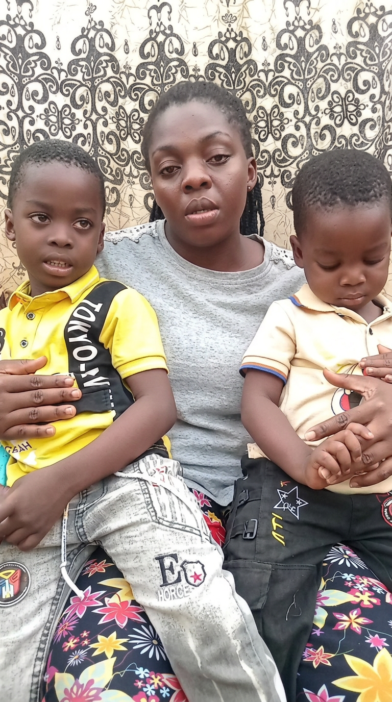 A woman seated with two young children
